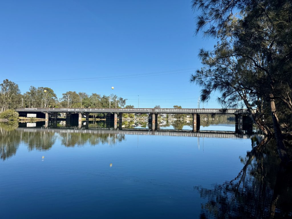 Dora Creek bridge and its reflection in calm water
